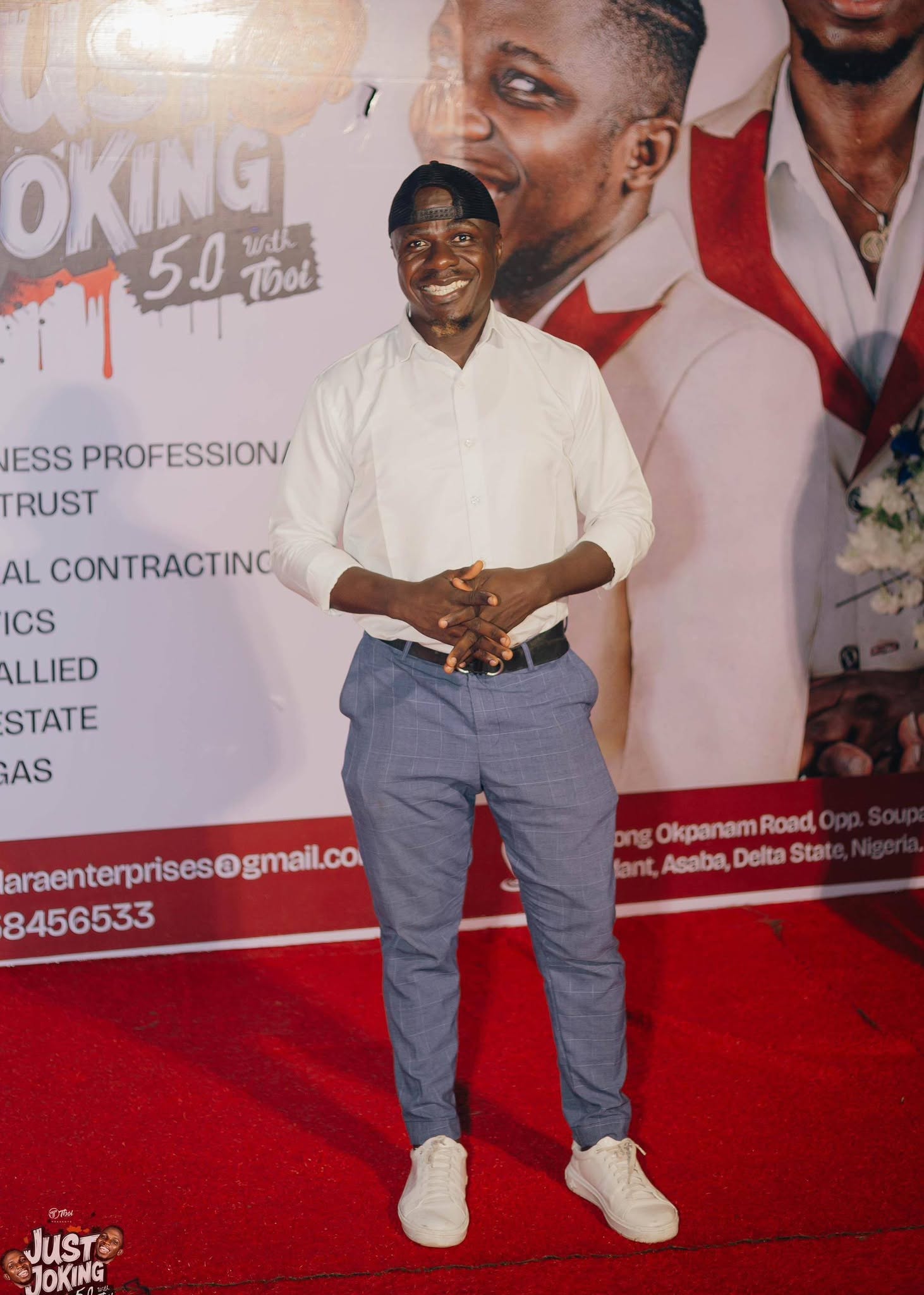 Edafe Dmouthpiece in front of Just Joking 5.0 event banner