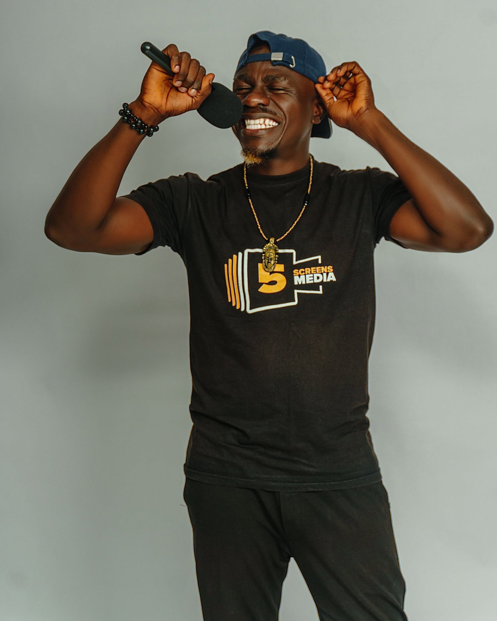 Edafe Dmouthpiece performing stand-up comedy on stage